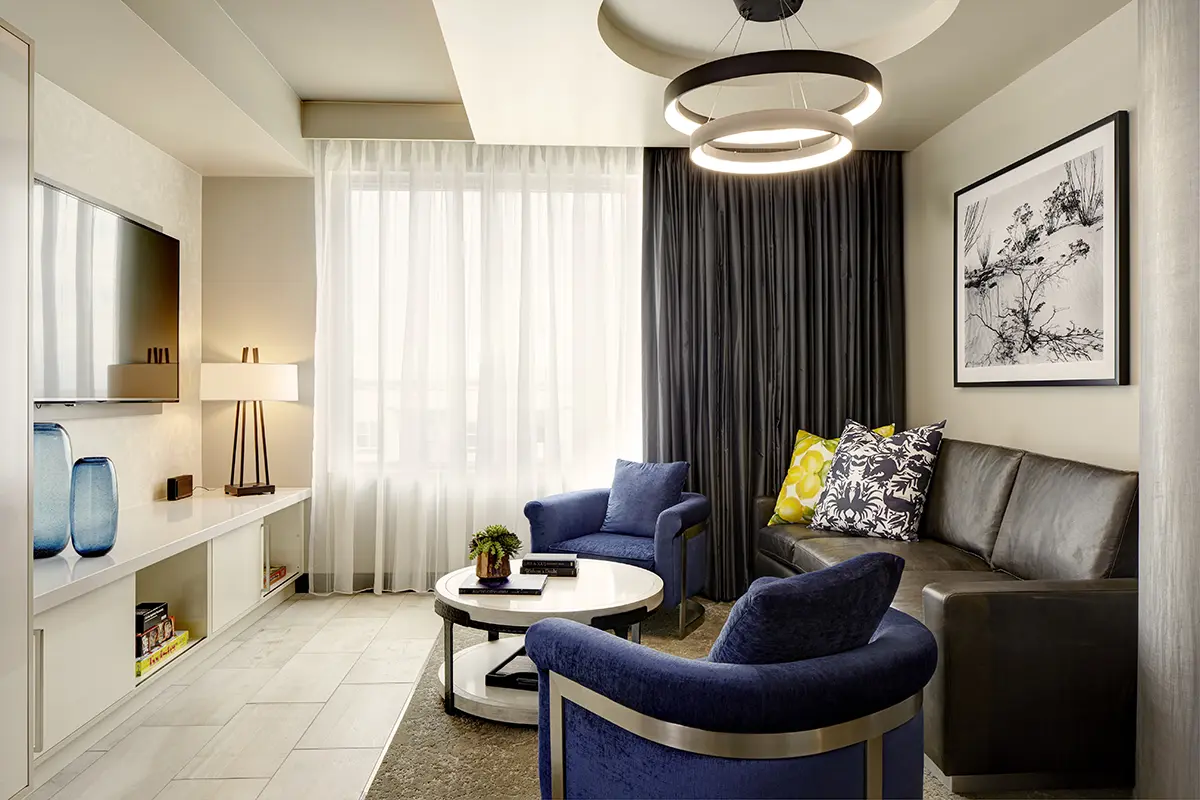 Archer's Den - separate living area with leather sofa and two lounge chairs