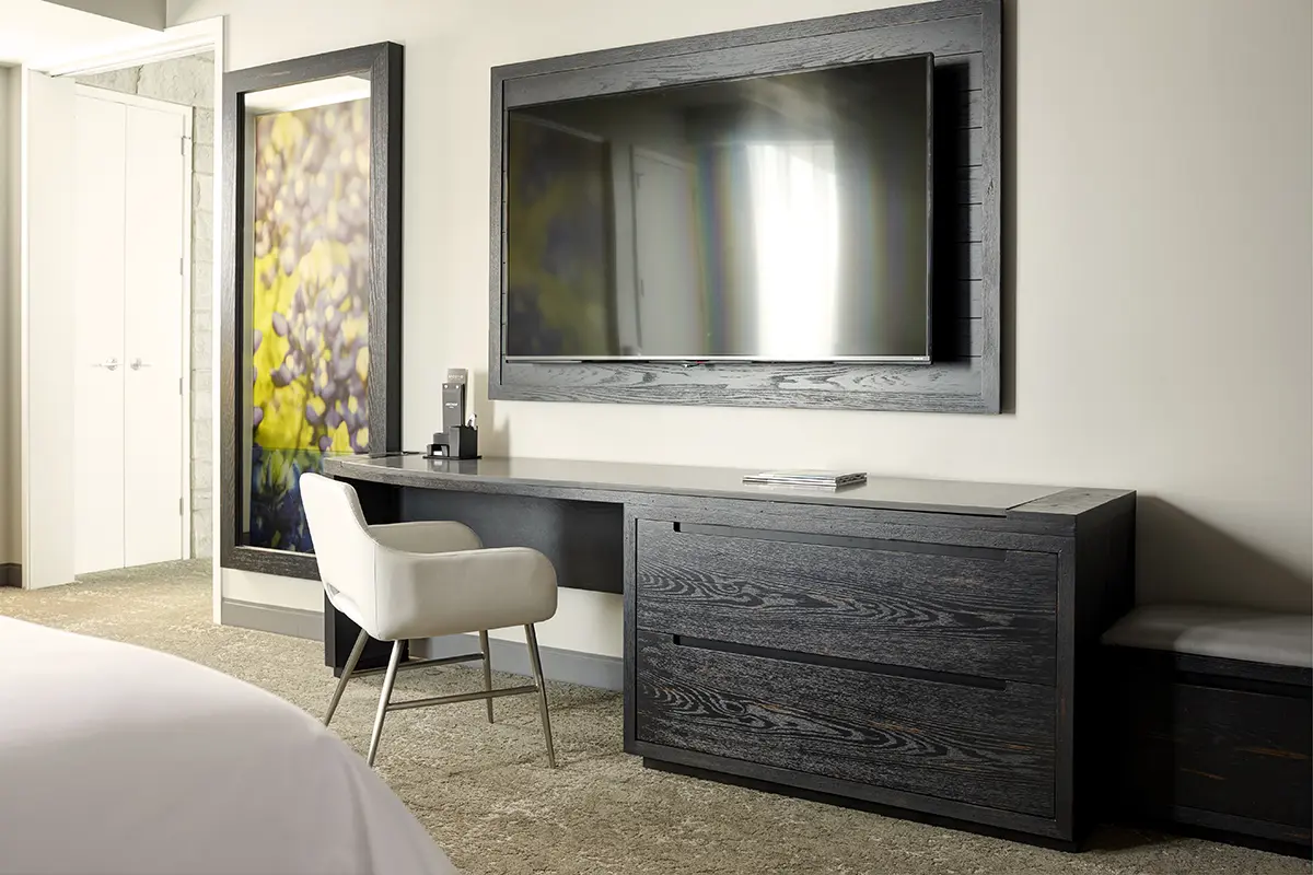 Archer's Den - bedroom desk with wall-mounted TV