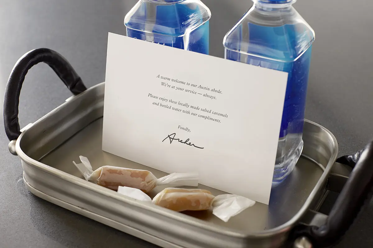 Welcome amenity of complimentary water, salted caramels and card