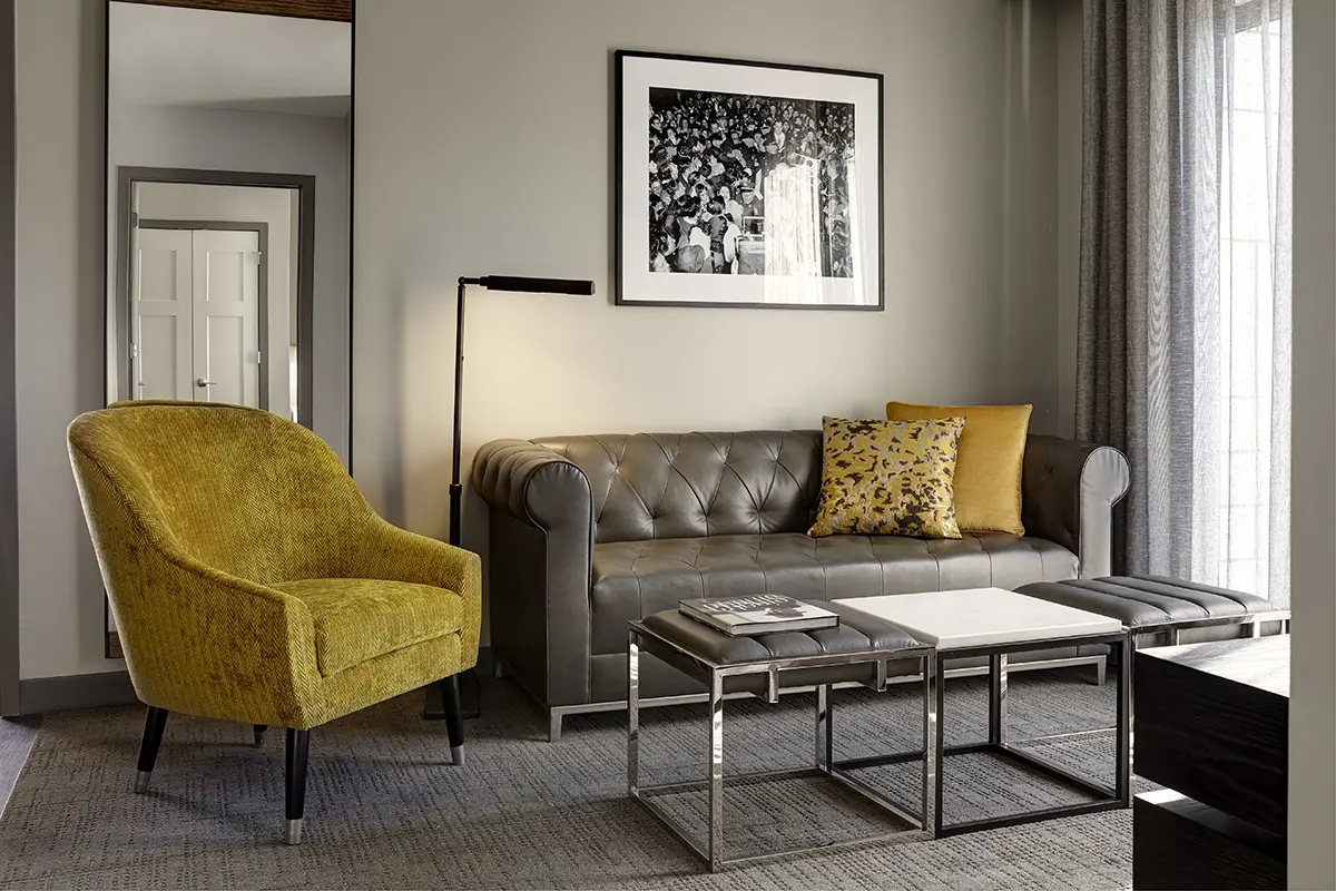 Archer's Den - separate living area furnished with a chesterfield-style sofa and side chair