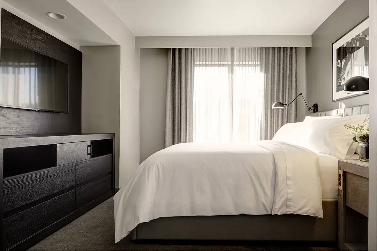 Archer's Den - private bedroom with platform bed and wall-mounted TV