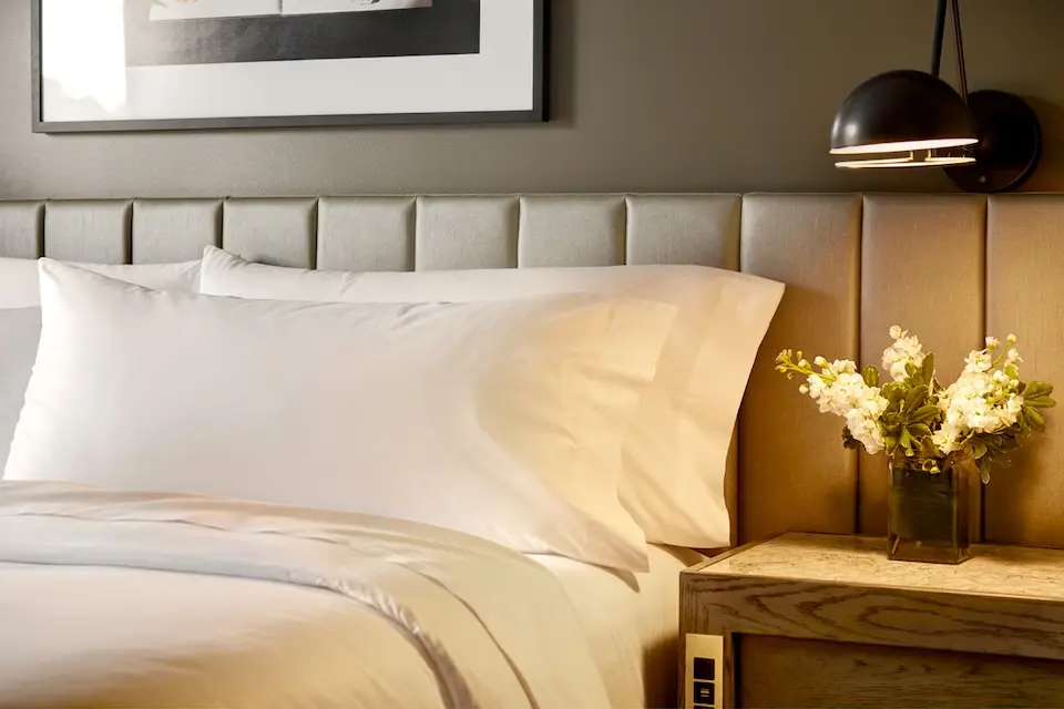 Archer's Den - bed with channel-tufted headboard and custom end table