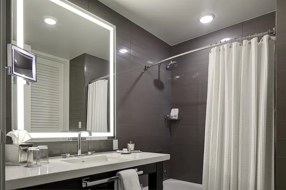 Double Queen - bathroom vanity and mirror with a tub-shower combo