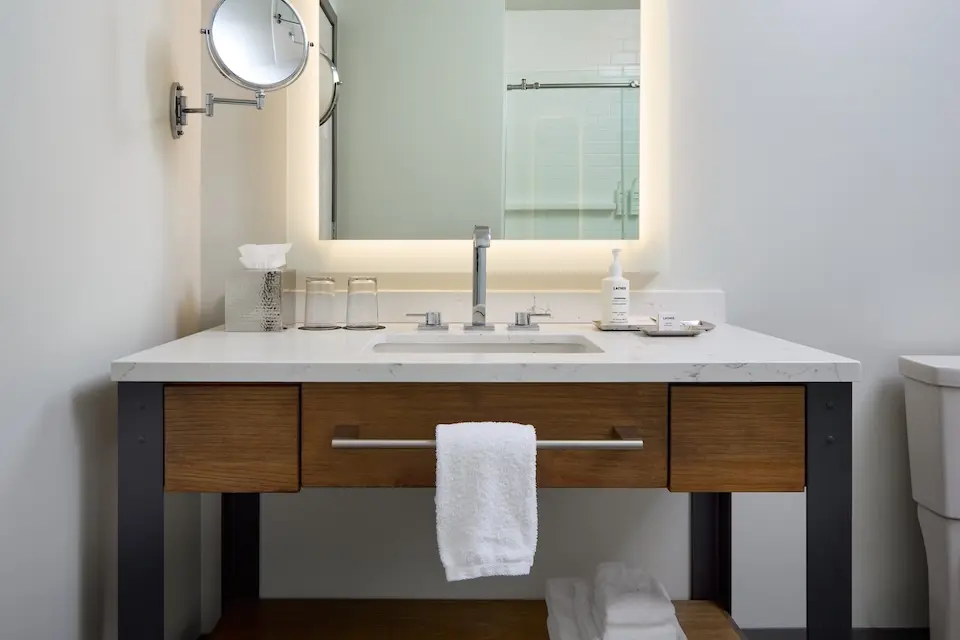 Classic King - modern bathroom with weathered iron vanity, mirror and luxury bath amenities