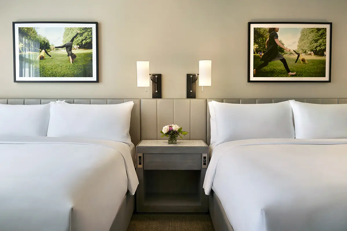 Double King beds with light fixtures and wall art