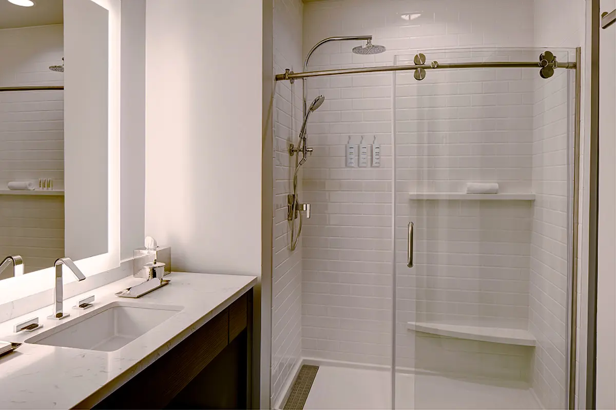 Modern bathroom with vanity and white subway-tile walk-in shower