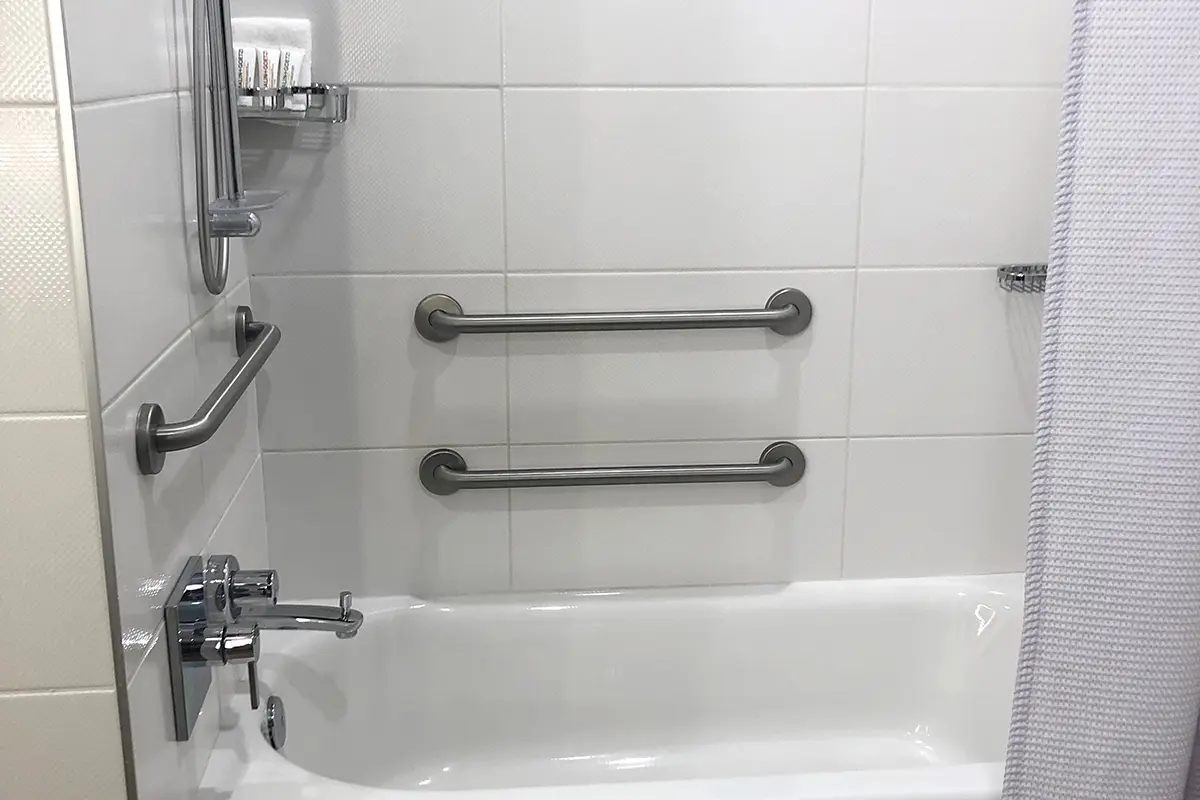 Classic King - mobility-accessible tub with grab bars and adjustable shower wand