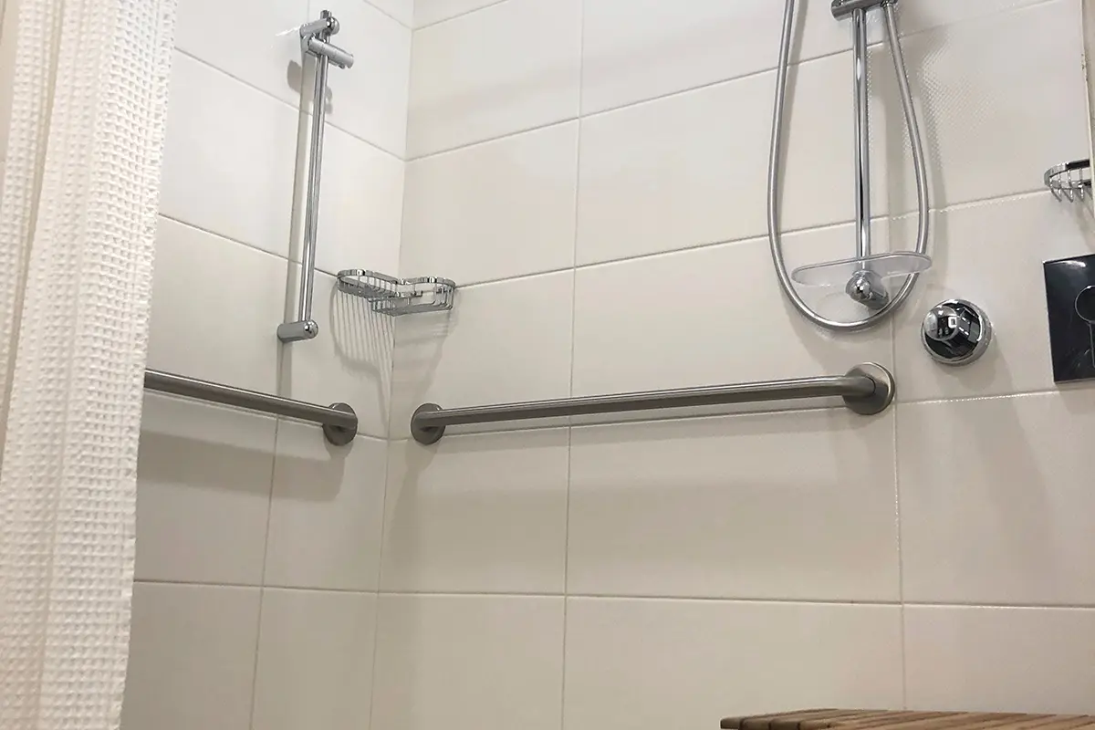 Double King - mobility-accessible roll-in shower with grab bars and hand-held shower wand