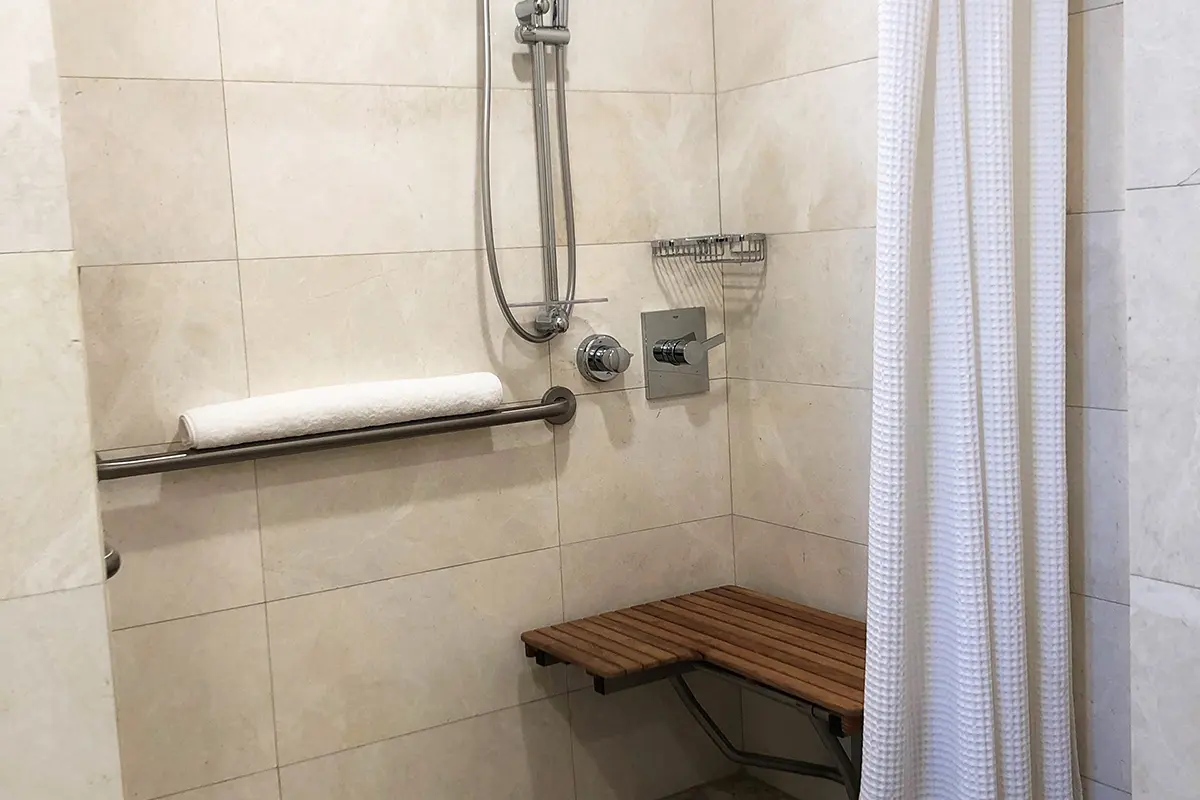 Archer's Den - mobility-accessible roll-in shower with shower seat and hand-held shower wand