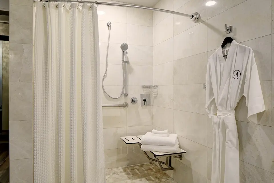 Archer's Den - mobility-accessible roll-in shower with shower seat and hand-held shower wand