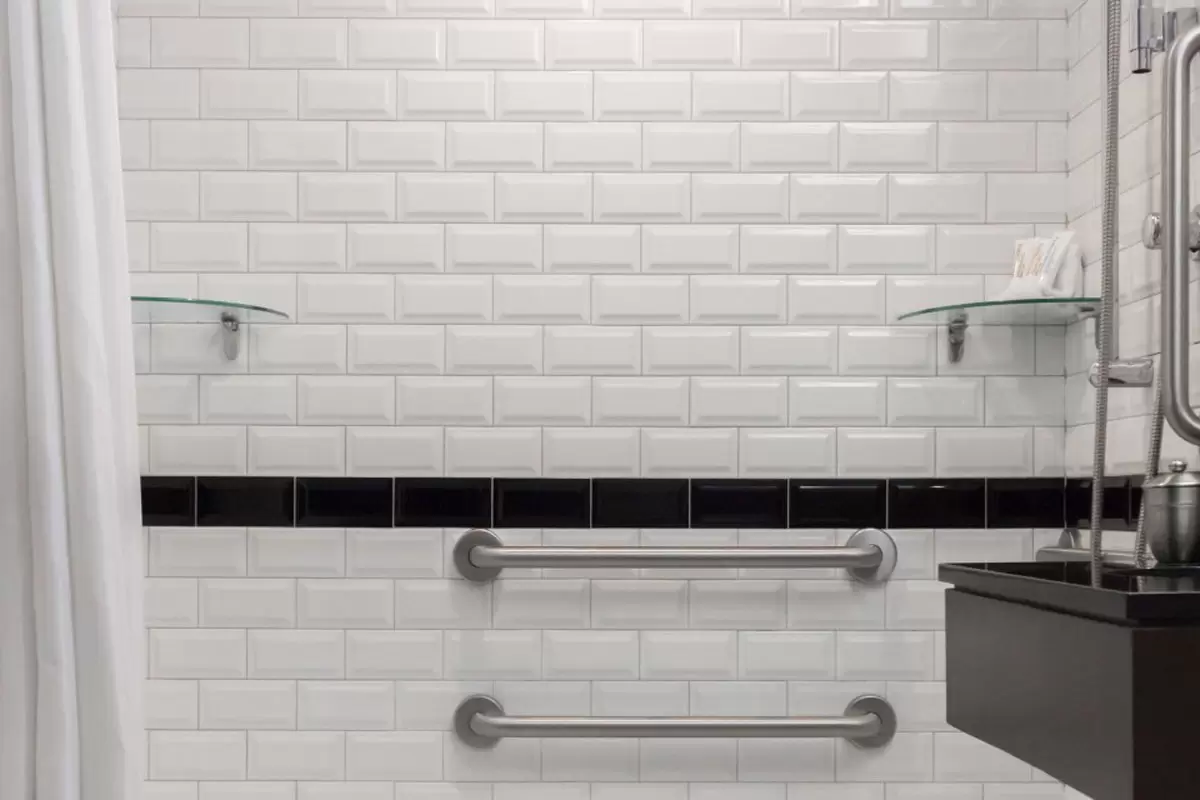 Classic King - mobility-accessible bathtub with grab bars and subway-tile walls