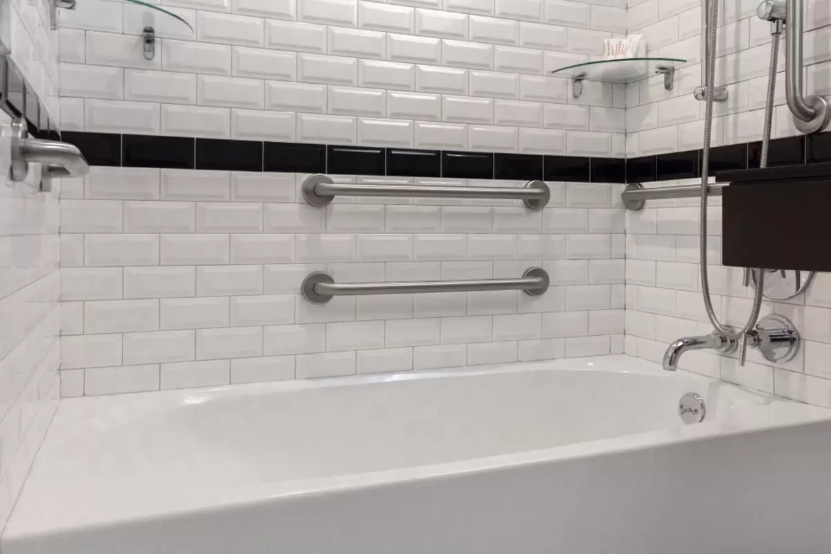Classic King - mobility-accessible bathtub with grab bars and subway-tile walls