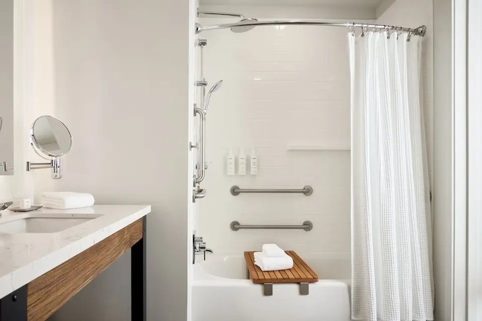 Classic King - mobility-accessible tub with grab bars and hand-held shower wand