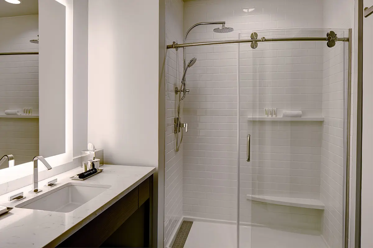 Modern bathroom with vanity and white subway-tile walk-in shower