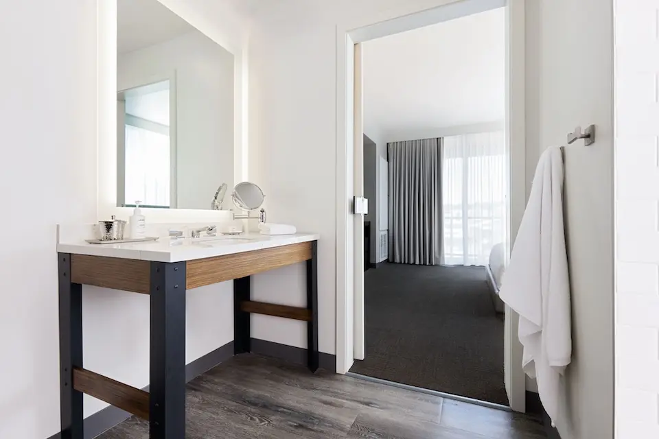 Archer’s Den - modern bathroom with a quartz double vanity and mirrors