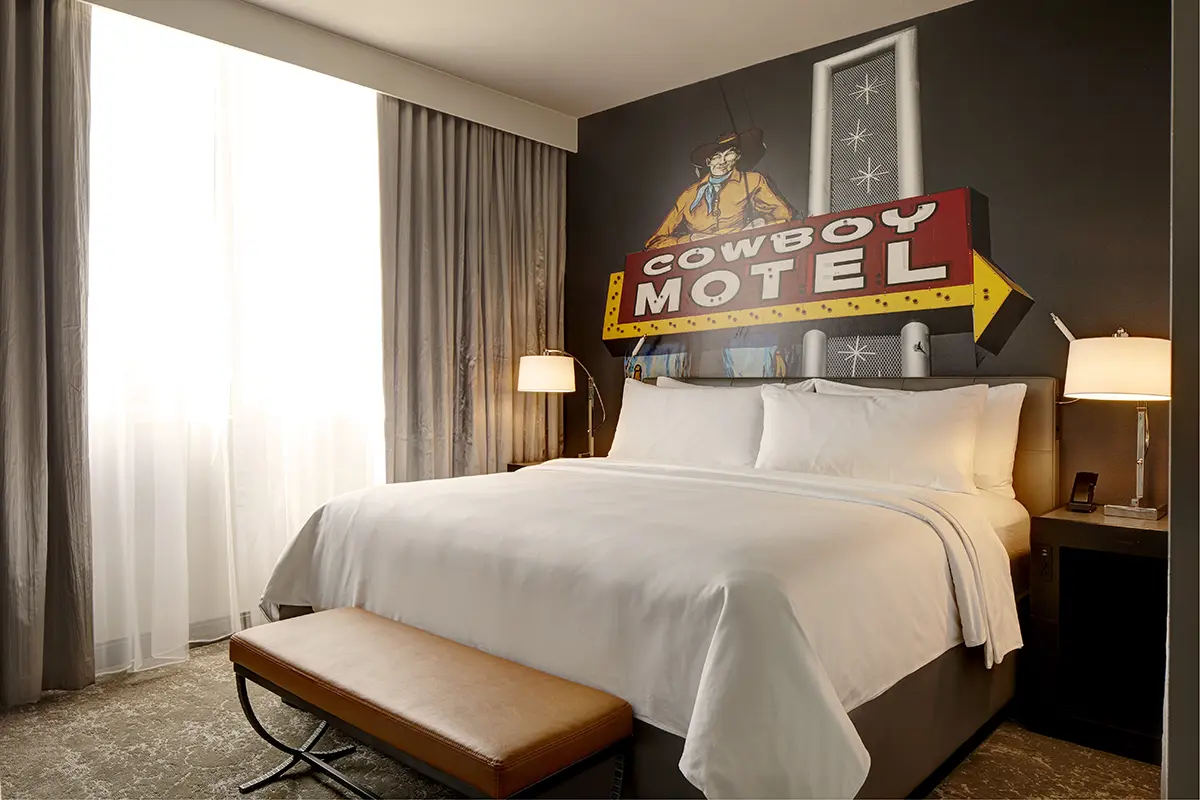 Classic King - bed with five-star bedding and local cowboy motel sign