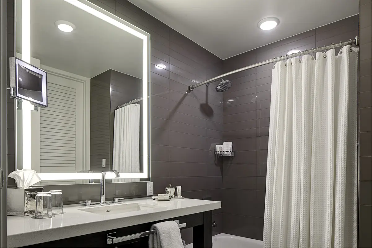 Elegant bathroom vanity, mirror and tub