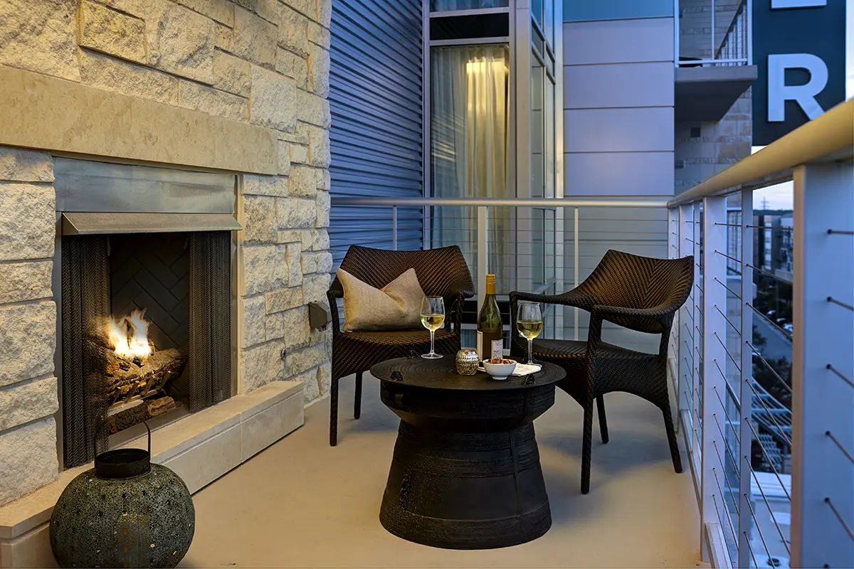 Balcony experience with lounge seating and limestone fireplace