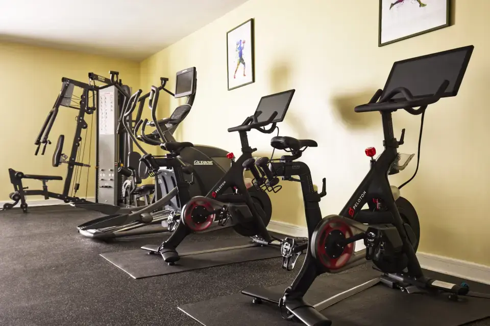 Fitness Studio - stationary studio bikes and elliptical trainer lined up next to a multi-station weight machine