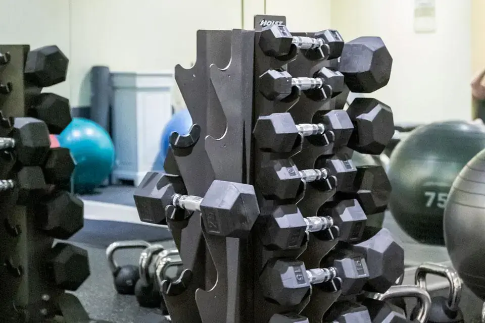 Fitness Studio - vertical dumbbell rack in front of a mirrored wall