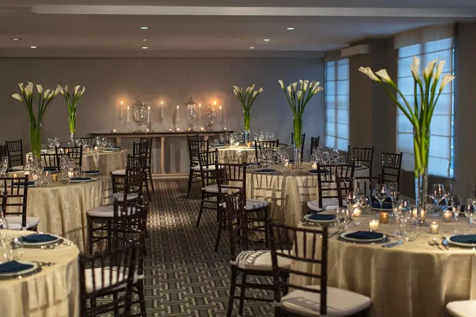 Round tables with white linen and flower arrangements
