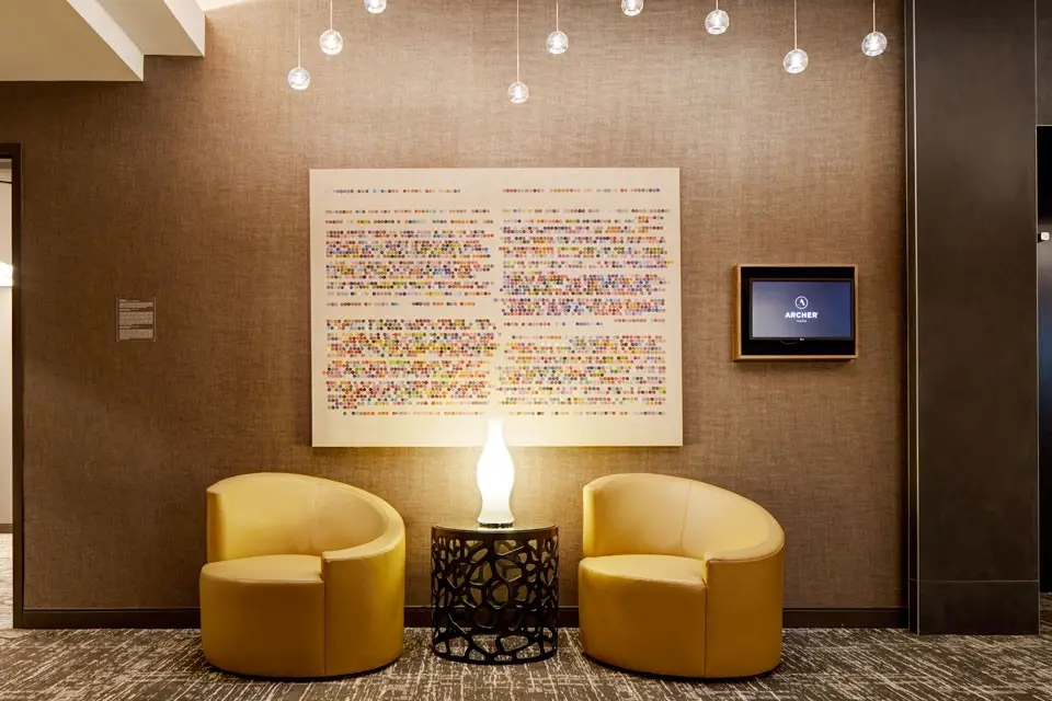 Two yellow chairs and art in the Grand Salon Foyer