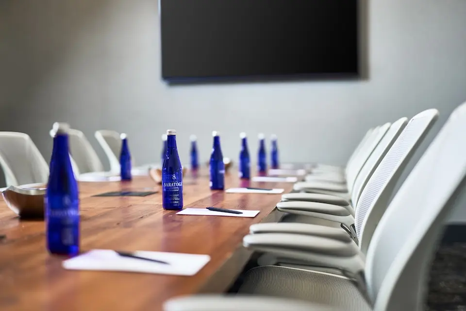 Archer Hotel Florham Park - Boardroom table with water and notepads