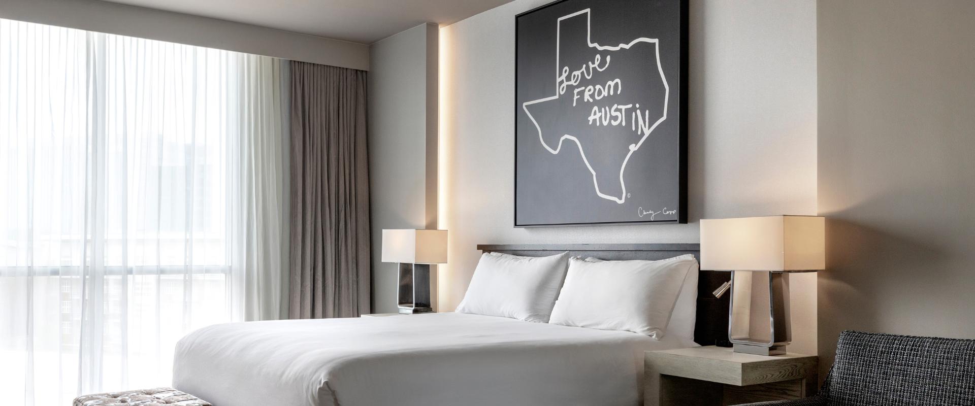 Guest room bed with Love from Archer art